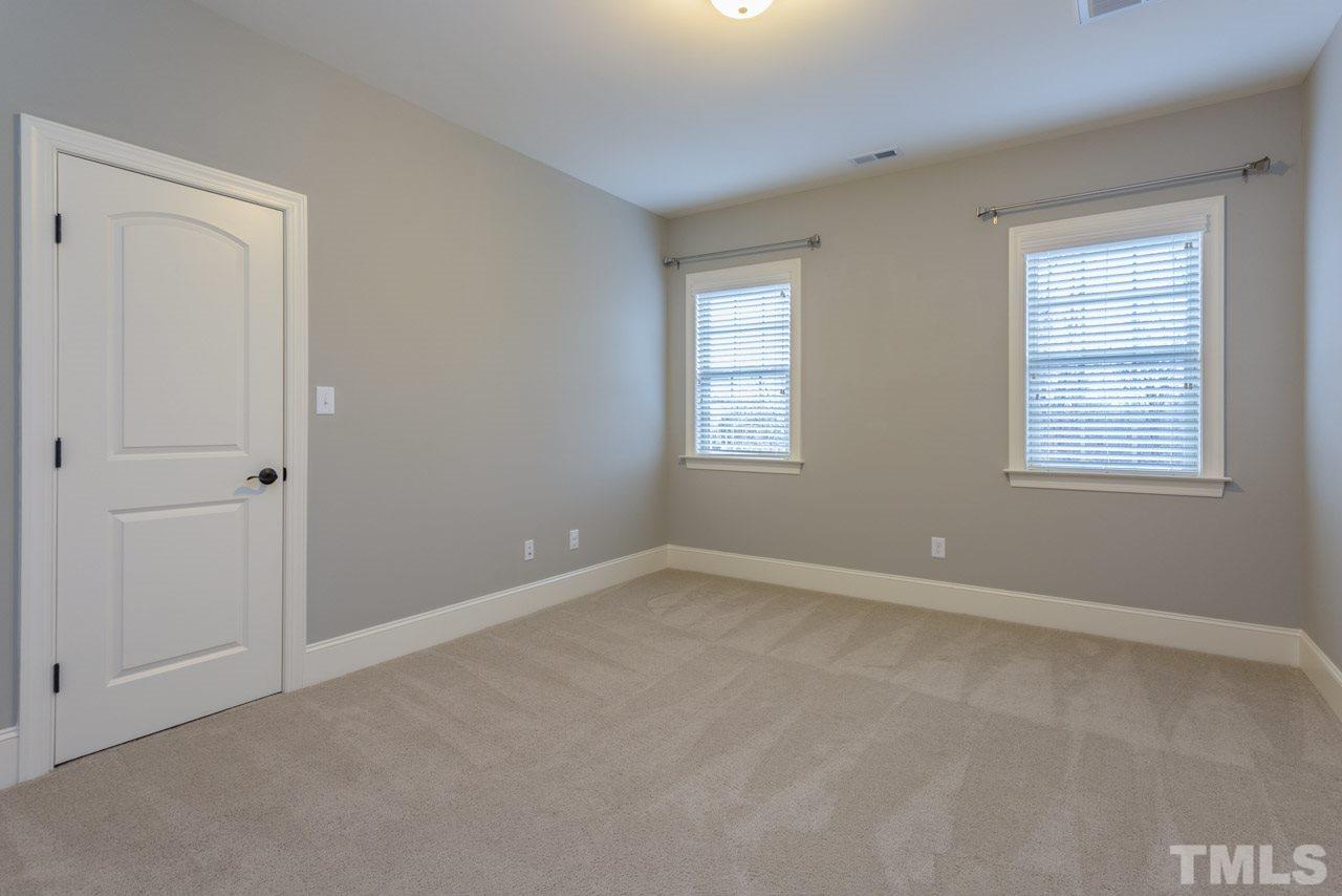 5011 Pomfret Point Raleigh, NC 27612 - Photo 16 of 25 Bedroom #4 features planation blinds, walk-in closet with wood shelving, and direct access to a full bath.