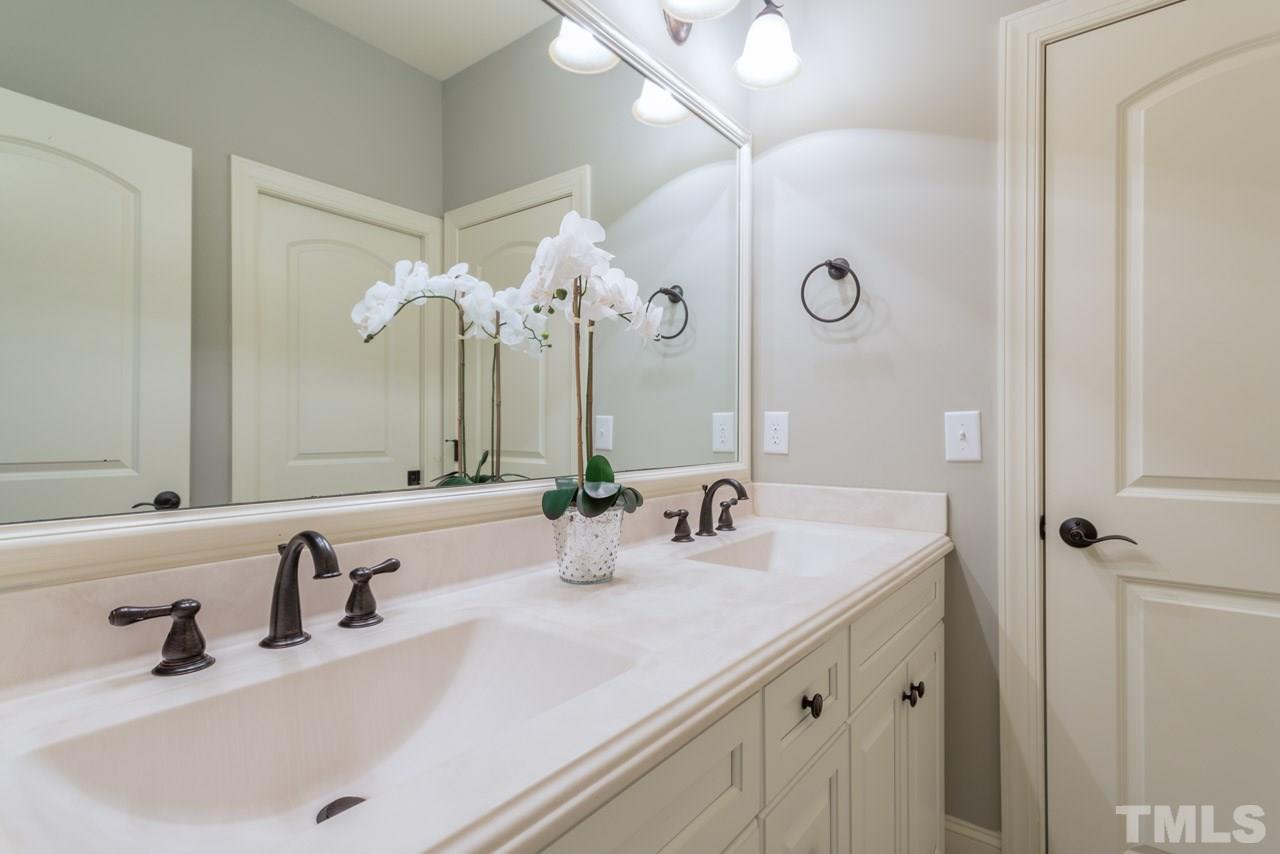 5011 Pomfret Point Raleigh, NC 27612 - Photo 17 of 25 This well designed bath features a cultured marble counter top with rectangular sinks and a framed mirror. Bathroom is divided into 2 sections: vanity area and a door that separates it from the tub/shower and toilet room. Directly adjoins Bedroom #4.