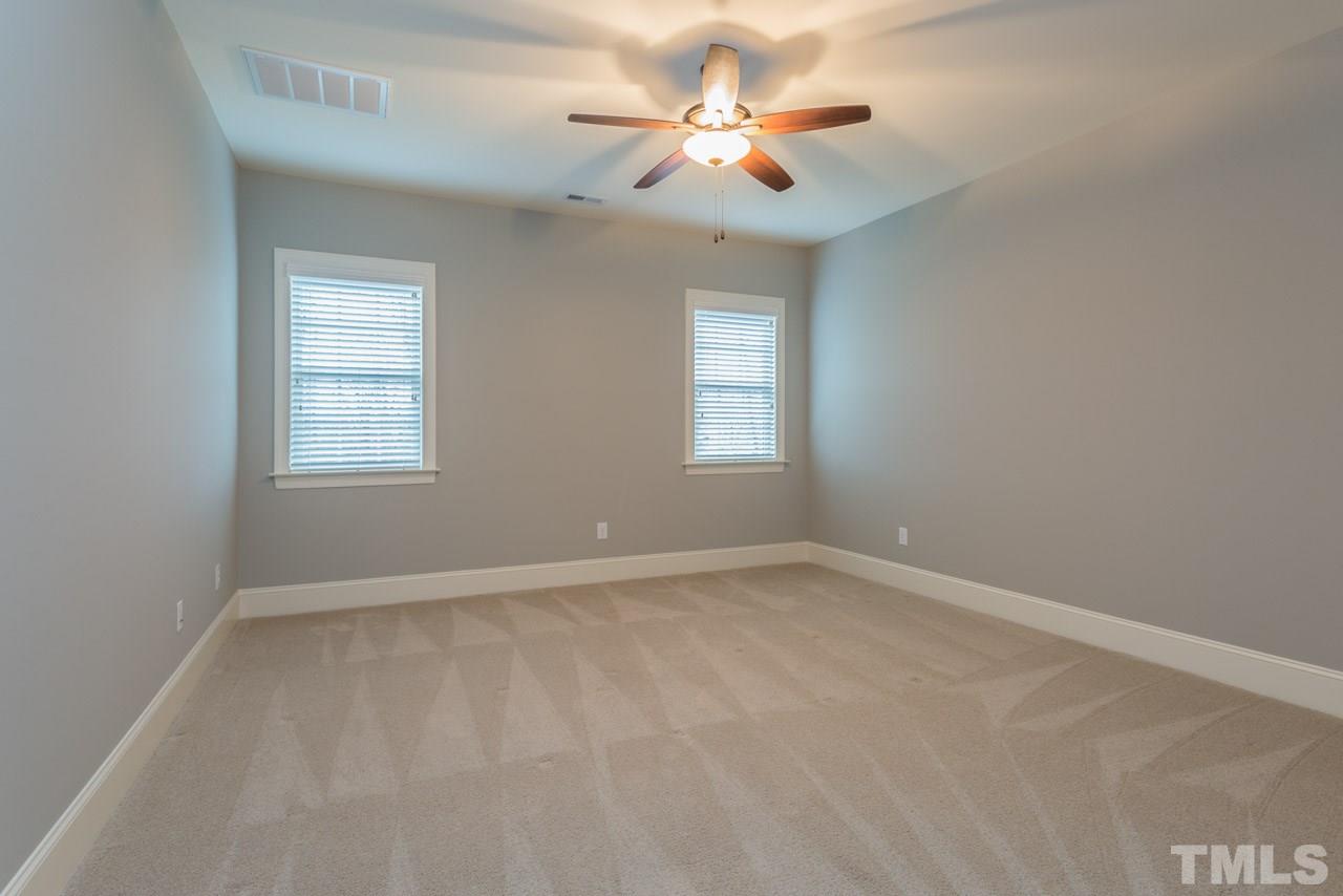 5011 Pomfret Point Raleigh, NC 27612 - Photo 18 of 25 Features include a ceiling fan, walk in closet, and plantation blinds.