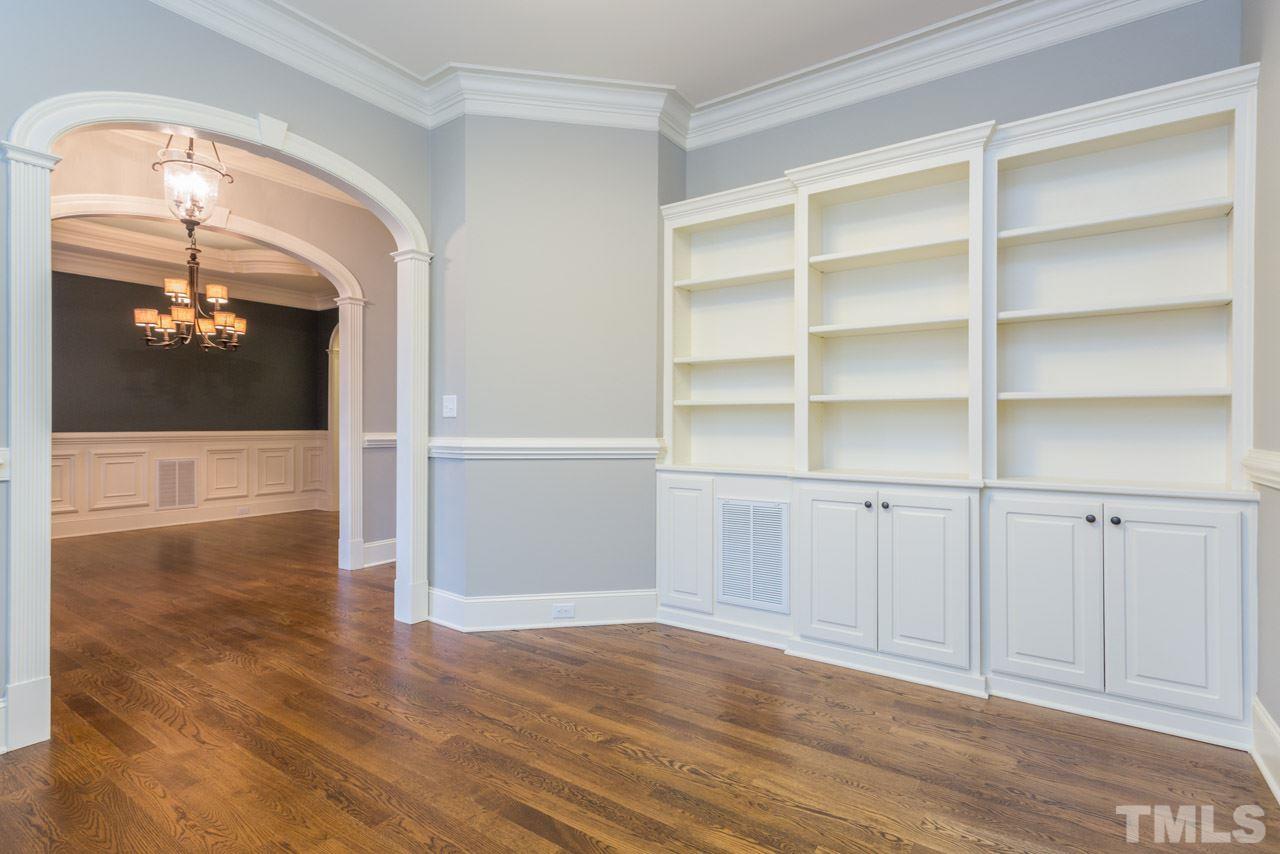 5011 Pomfret Point Raleigh, NC 27612 - Photo 3 of 25 The 1st floor office enjoys a wall of custom-built bookcases, hardwood floors, crown molding, chair railing, and plantation shutters.