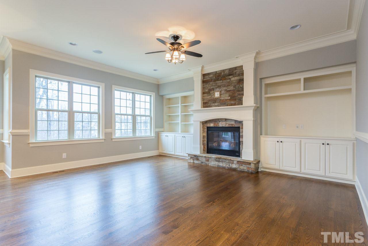 5011 Pomfret Point Raleigh, NC 27612 - Photo 4 of 25 The expansive family room offers a gas fireplace with stone surround that is framed with double bookcases. Additional features include hardwood floors, ceiling fan, chair railing and crown molding. Pre-wired speakers for distributed audio.