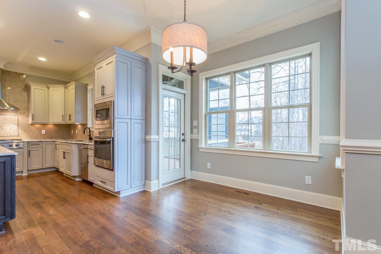 5011 Pomfret Point Raleigh, NC 27612 - Photo 9 of 25 The breakfast room is open to the kitchen and family room and features a wall of triple windows and access to the screen porch.