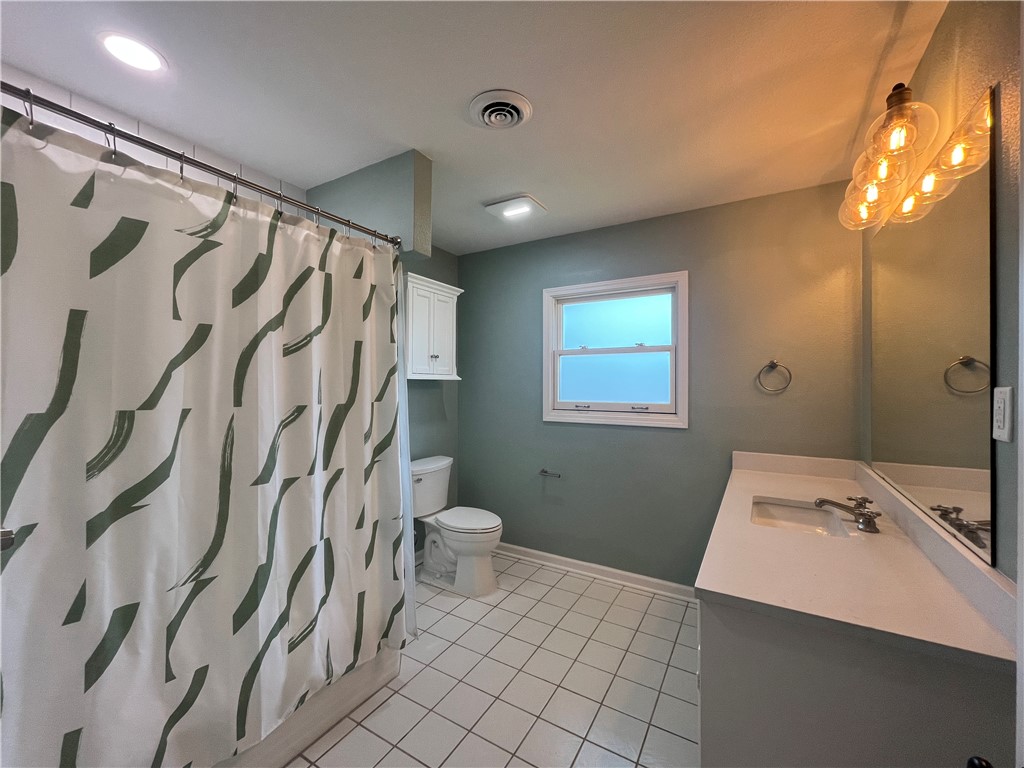 353 Jackson Place Corpus Christi, TX 78411 - Photo 15 of 24 a bathroom with a sink a toilet and shower