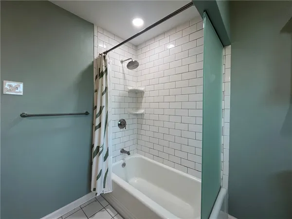 a bathroom with a bathtub and a shower
