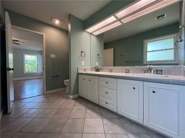 a spacious bathroom with a double vanity sink mirror and