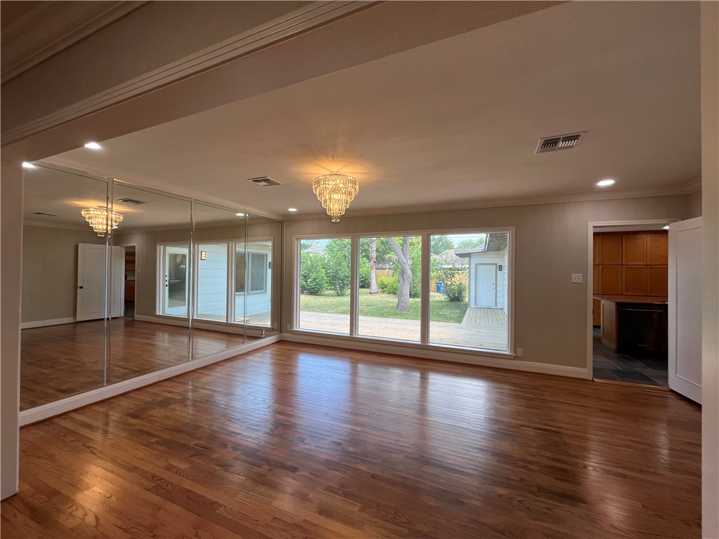 353 Jackson Place Corpus Christi, TX 78411 - Photo 4 of 24 a view of an empty room with wooden floor and a window