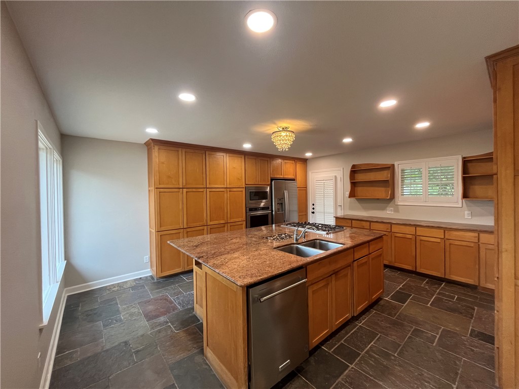 353 Jackson Place Corpus Christi, TX 78411 - Photo 8 of 24 a kitchen that has a sink a stove and a table in it