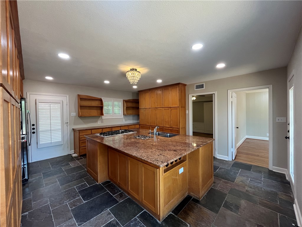353 Jackson Place Corpus Christi, TX 78411 - Photo 9 of 24 a kitchen with a stove a refrigerator a sink and a oven