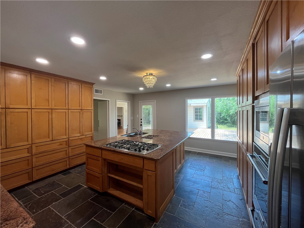 353 Jackson Place Corpus Christi, TX 78411 - Photo 10 of 24 a kitchen that has a stove and a wooden floor