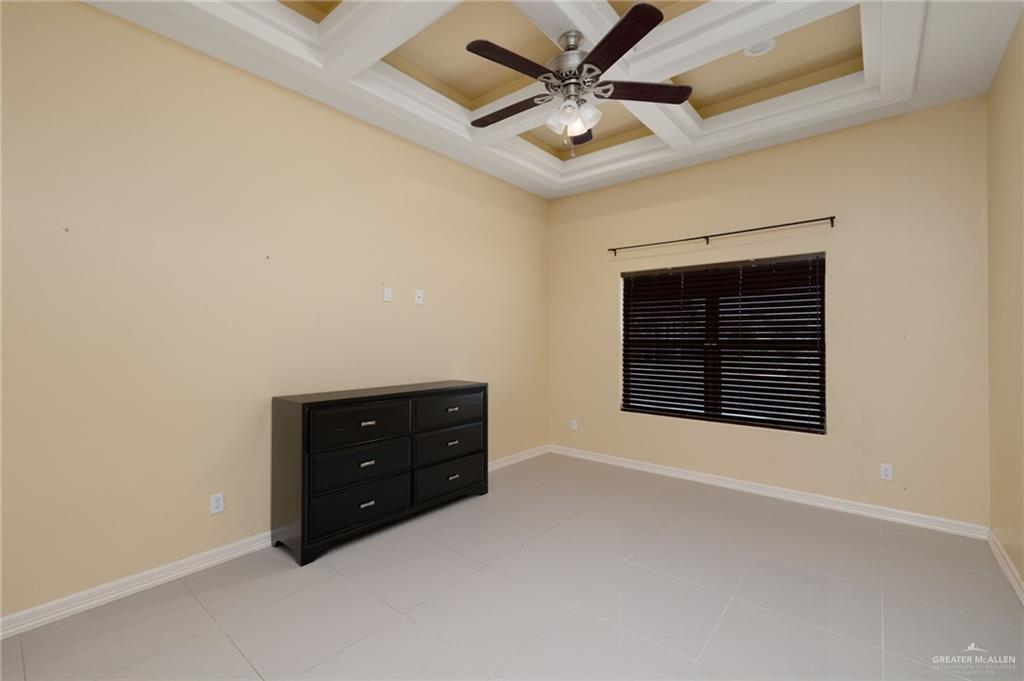 501 Olmo Street Mission, TX 78572 - Photo 7 of 17 an empty room with a ceiling fan and a window