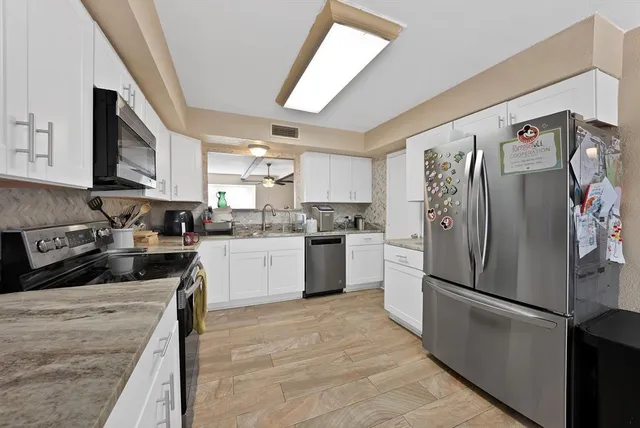 a view of a room with a window and wooden floor