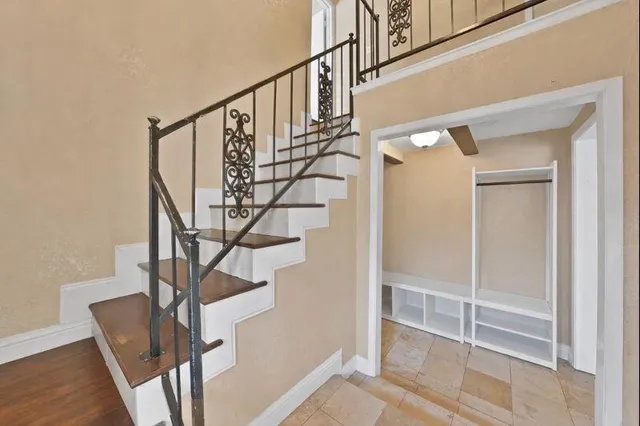 a view of entryway with wooden floor and stairs