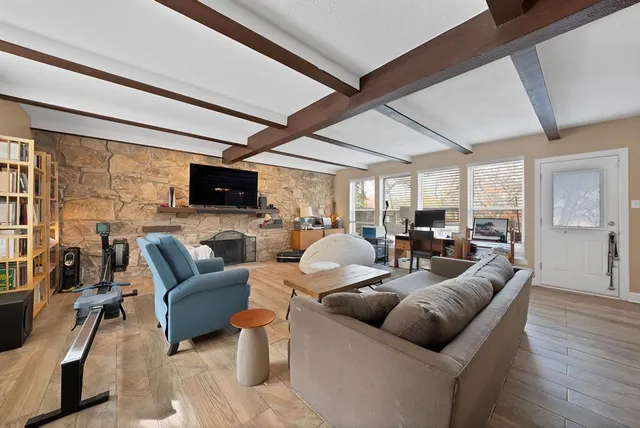 a living room with furniture and wooden floor