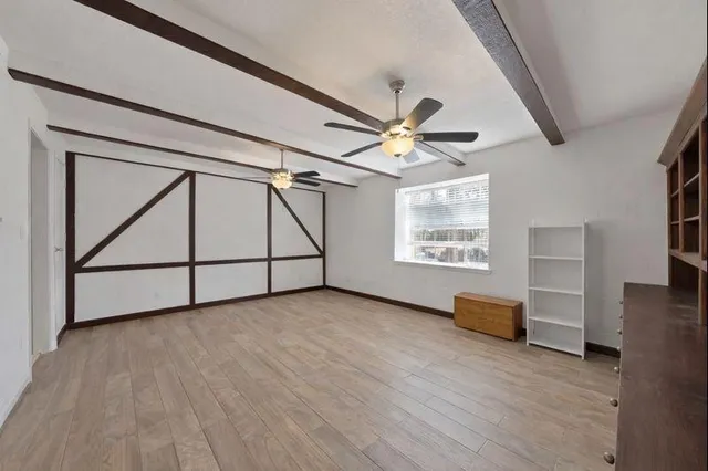 a bedroom with furniture and a wooden floor
