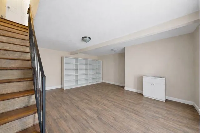 a view of a livingroom with furniture and an empty room