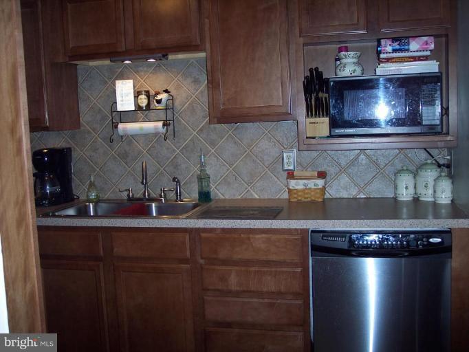 126 Malbrook Road Baltimore, MD 21229 - Photo 13 of 20 a kitchen with a refrigerator and a stove