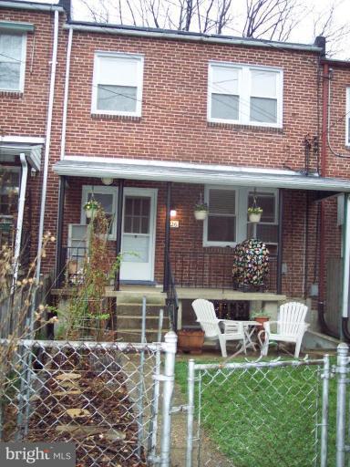 126 Malbrook Road Baltimore, MD 21229 - Photo 17 of 20 a view of a house with a yard and sitting area
