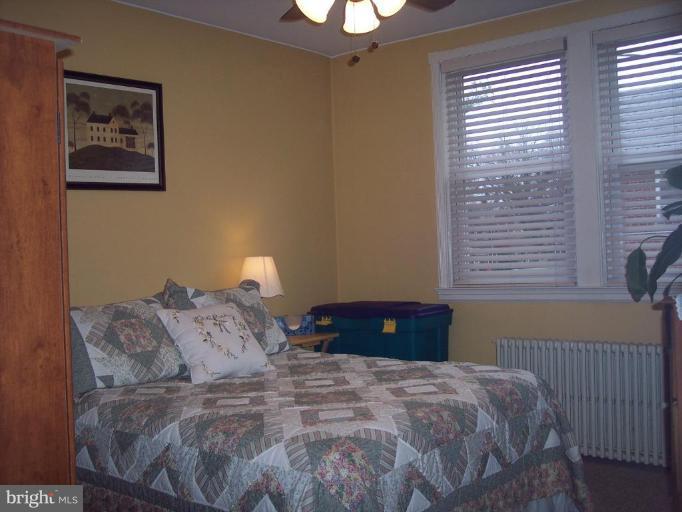 126 Malbrook Road Baltimore, MD 21229 - Photo 3 of 20 a bedroom with a bed and a window