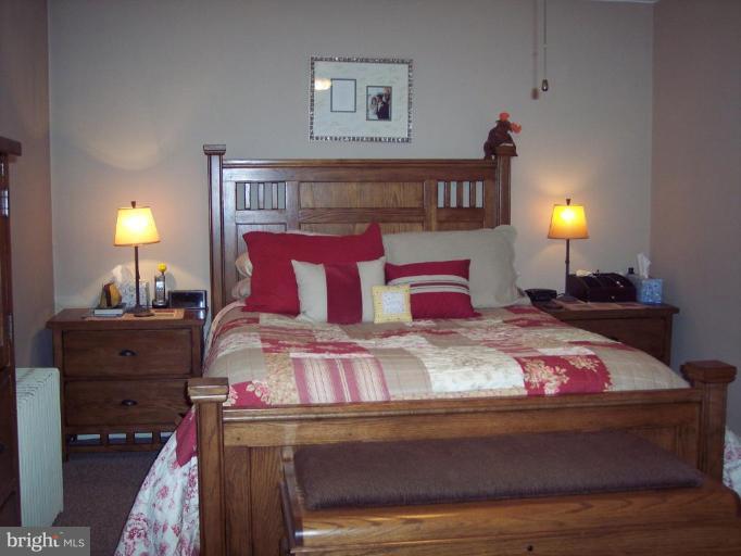 126 Malbrook Road Baltimore, MD 21229 - Photo 4 of 20 a bedroom with a bed and lamp with table