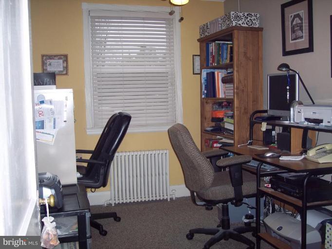 126 Malbrook Road Baltimore, MD 21229 - Photo 5 of 20 a view of a workspace with furniture and wooden floor