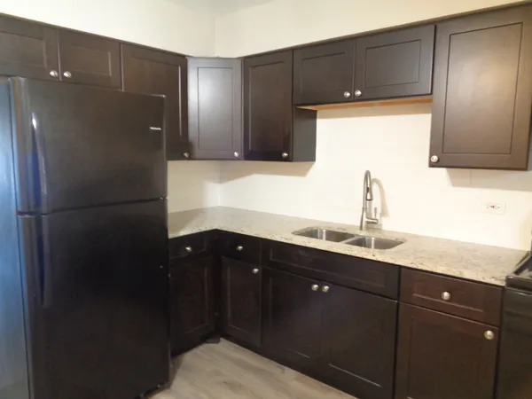 a kitchen with a sink and refrigerator