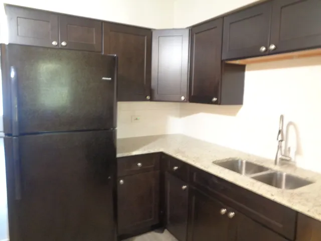 a kitchen with a sink and a refrigerator