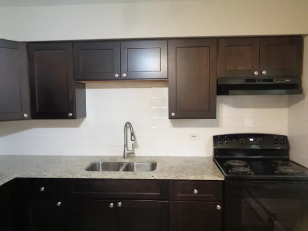 a kitchen with a sink and cabinets