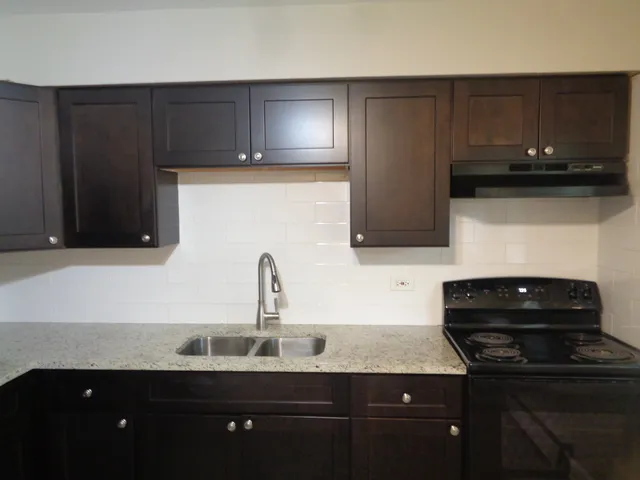 a kitchen with a sink and cabinets