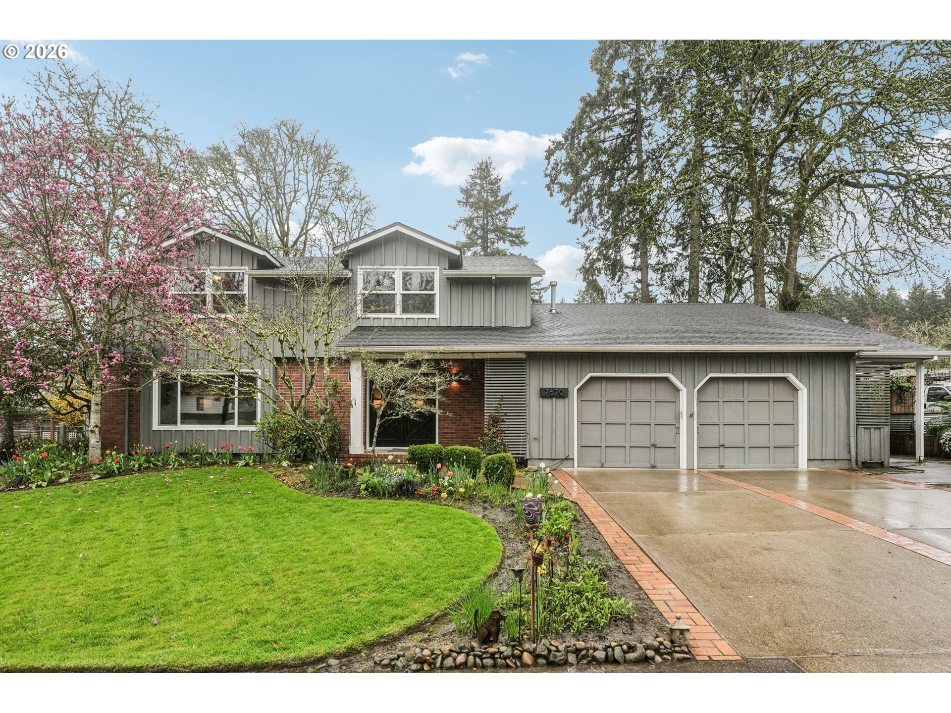 7670 Southwest Danielle Avenue Beaverton, OR 97008 - Photo 1 of 38 a front view of a house with a yard