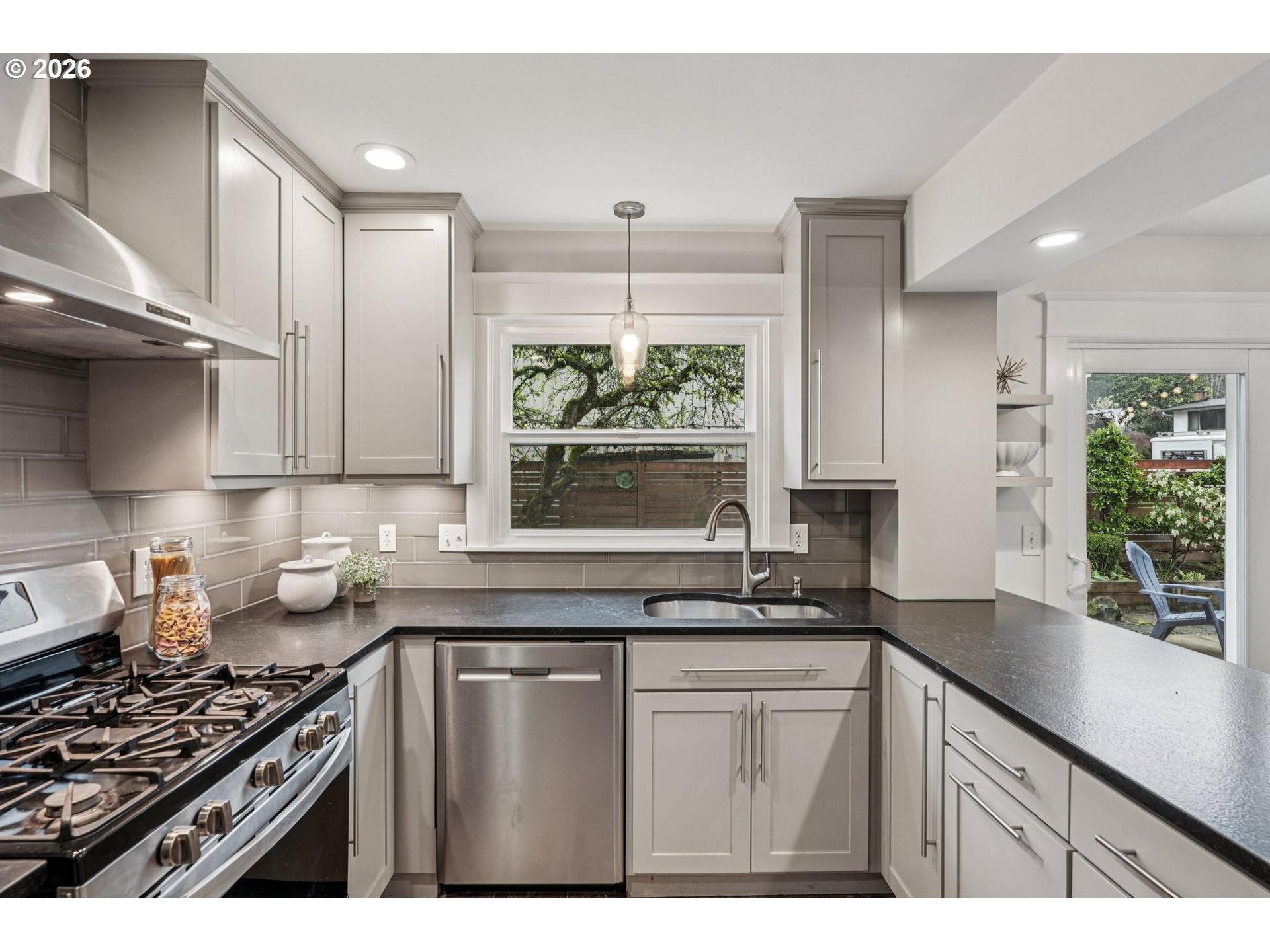 7670 Southwest Danielle Avenue Beaverton, OR 97008 - Photo 12 of 38 a kitchen with stainless steel appliances a sink stove and cabinets