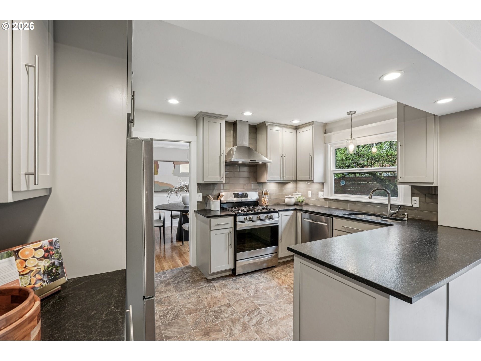 7670 Southwest Danielle Avenue Beaverton, OR 97008 - Photo 13 of 38 a kitchen with kitchen island a sink stainless steel appliances and cabinets