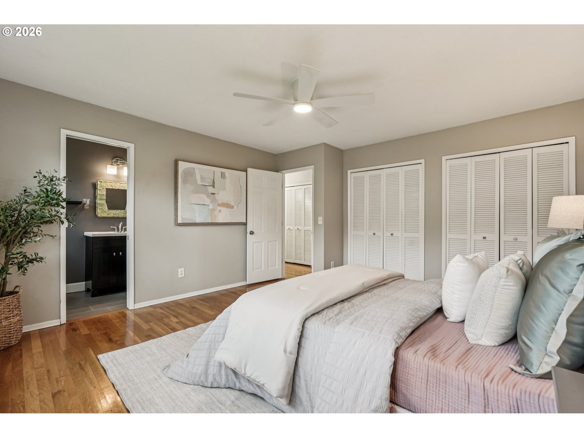 7670 Southwest Danielle Avenue Beaverton, OR 97008 - Photo 18 of 38 a bedroom with a large bed and a chandelier