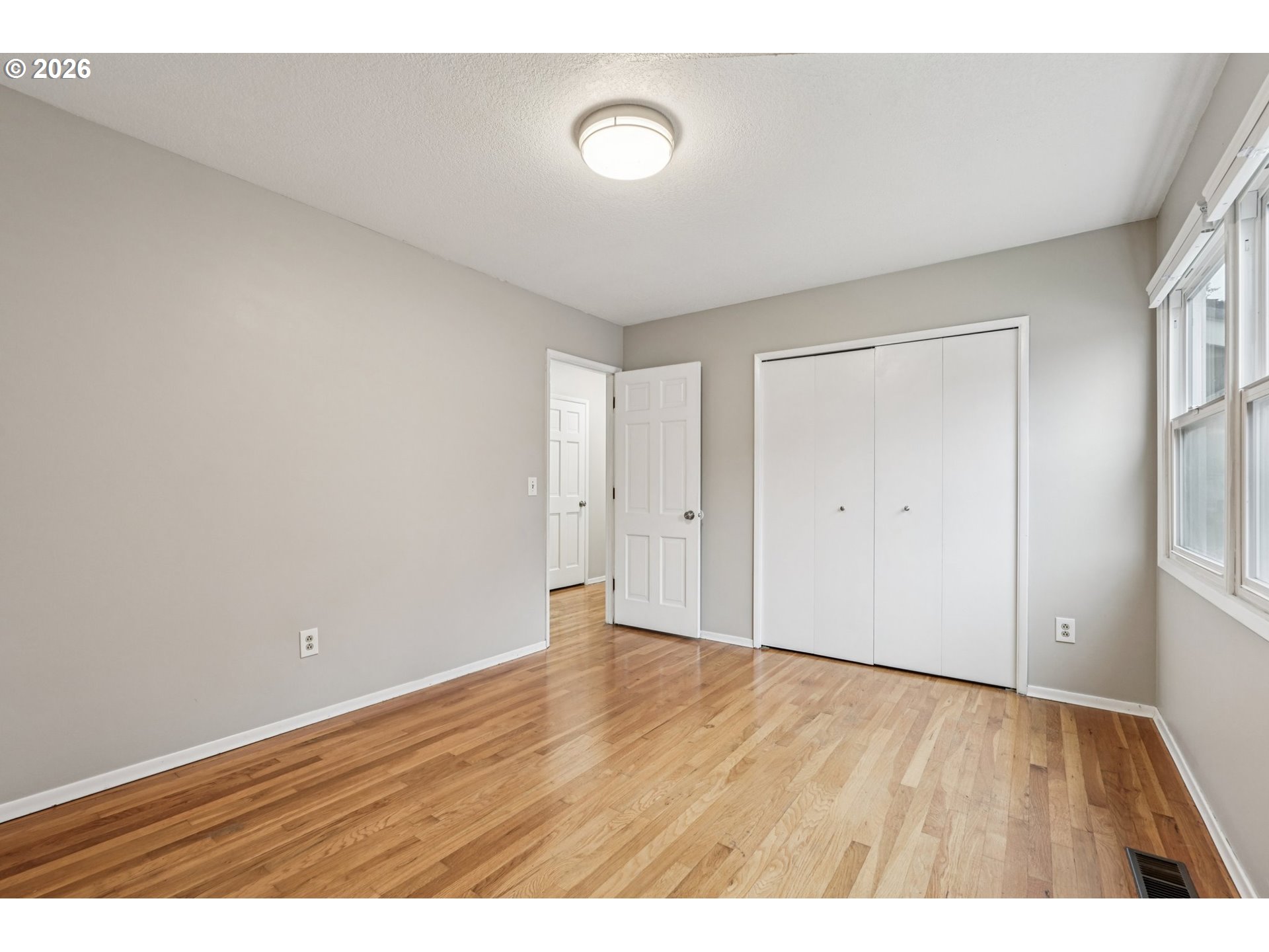 7670 Southwest Danielle Avenue Beaverton, OR 97008 - Photo 24 of 38 a view of an empty room with wooden floor