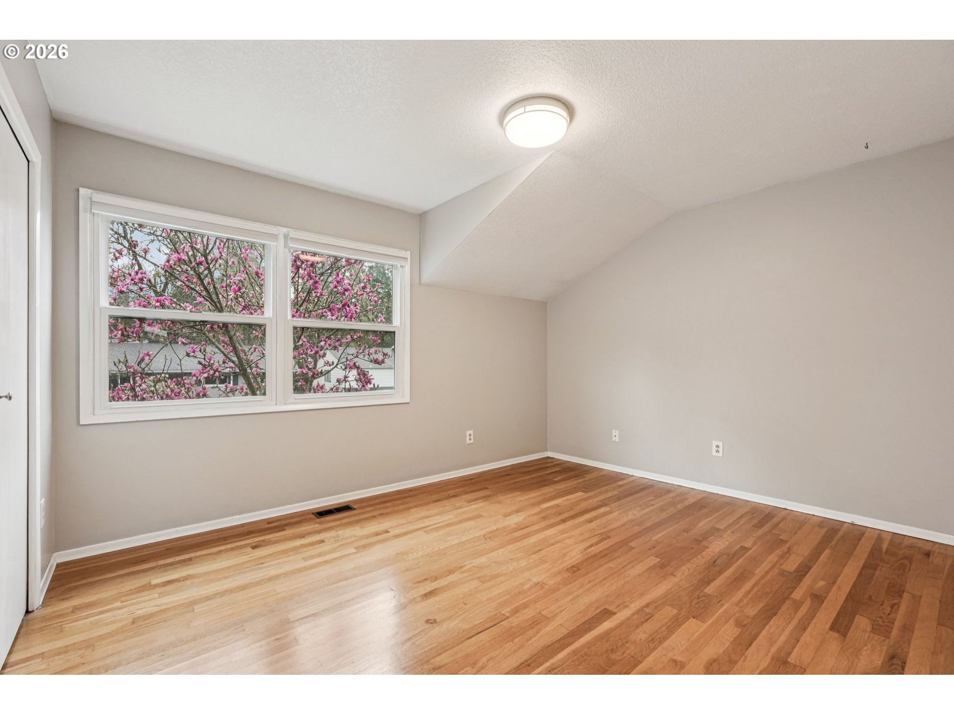 7670 Southwest Danielle Avenue Beaverton, OR 97008 - Photo 26 of 38 a view of an empty room with window and hardwood floor