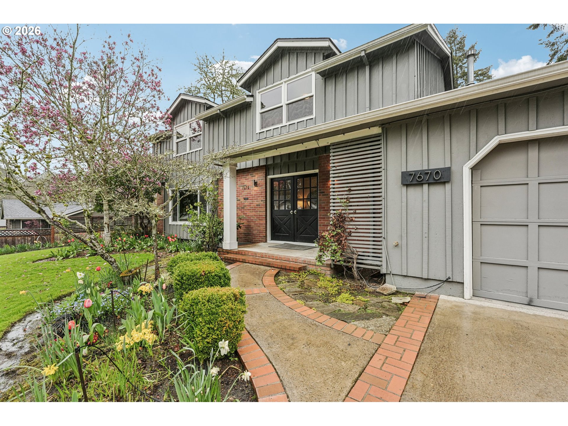 7670 Southwest Danielle Avenue Beaverton, OR 97008 - Photo 4 of 38 a front view of a house with a garden