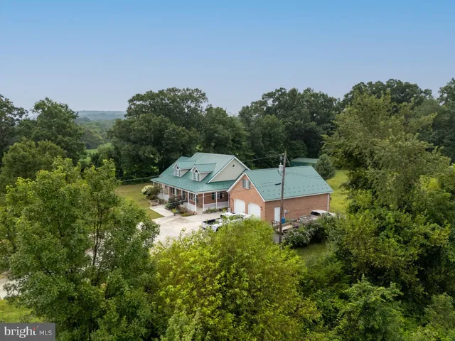 a living room with kitchen island furniture and a chandelier