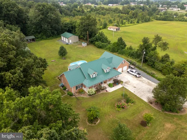 a aerial view of a house with a garden and lake view