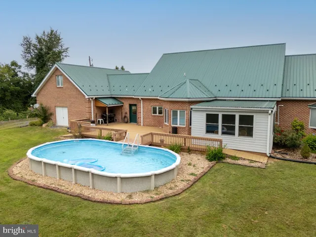 an aerial view of green landscape with trees houses and mountain view
