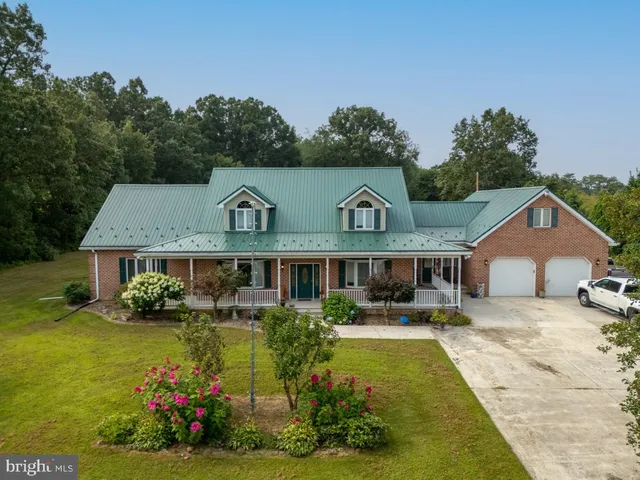 a large kitchen with stainless steel appliances wooden floors and wooden cabinets
