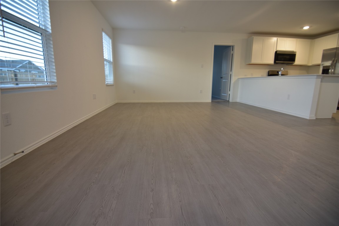 343 Keefer Kyle, TX 78640 - Photo 11 of 38 Unfurnished living room featuring dark wood-style flooring and recessed lighting