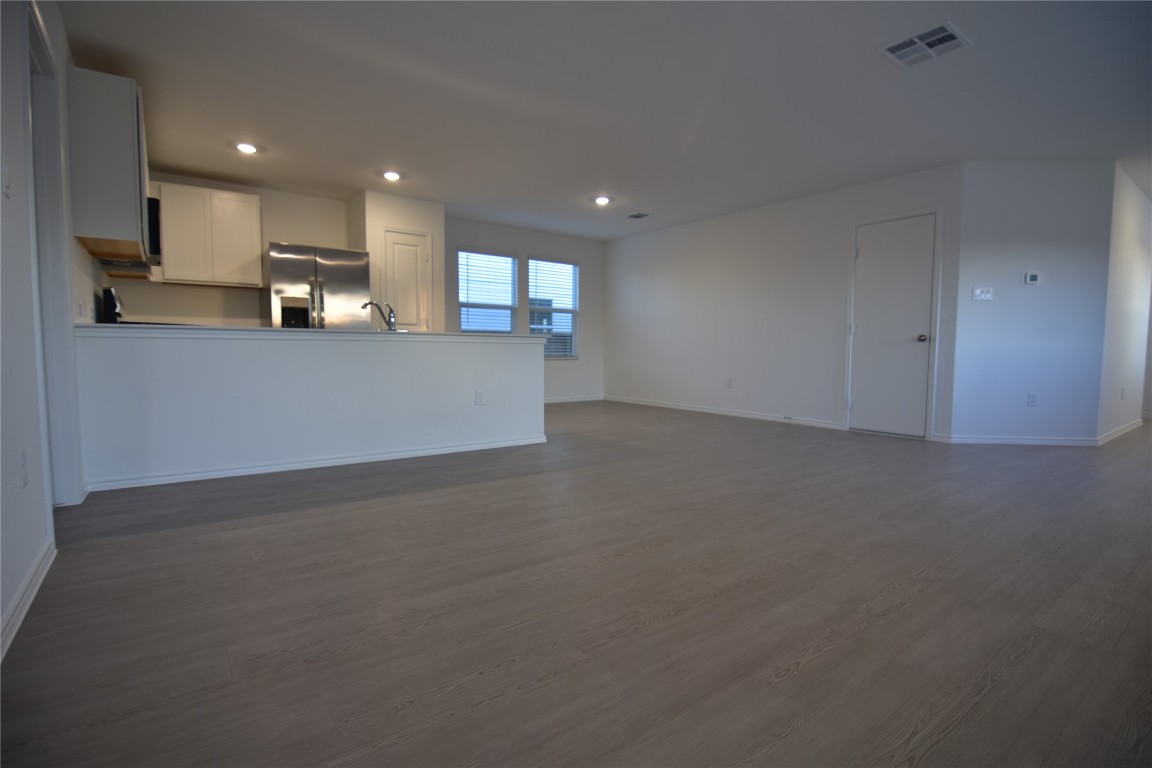 343 Keefer Kyle, TX 78640 - Photo 12 of 38 Unfurnished living room featuring recessed lighting and dark wood-style floors