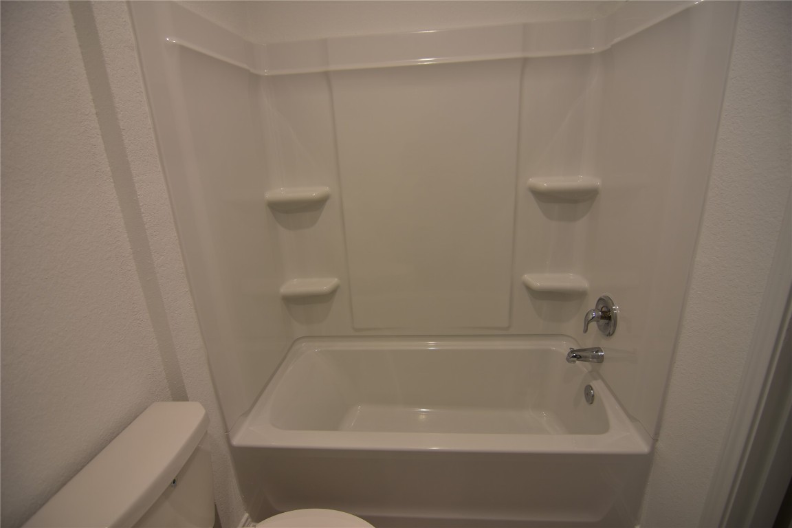 343 Keefer Kyle, TX 78640 - Photo 14 of 38 Bathroom with tub / shower combination and a textured wall