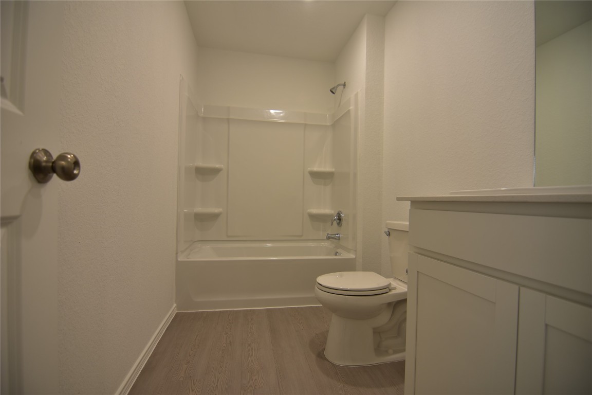 343 Keefer Kyle, TX 78640 - Photo 17 of 38 Full bathroom with dark wood finished floors, tub / shower combination, and vanity