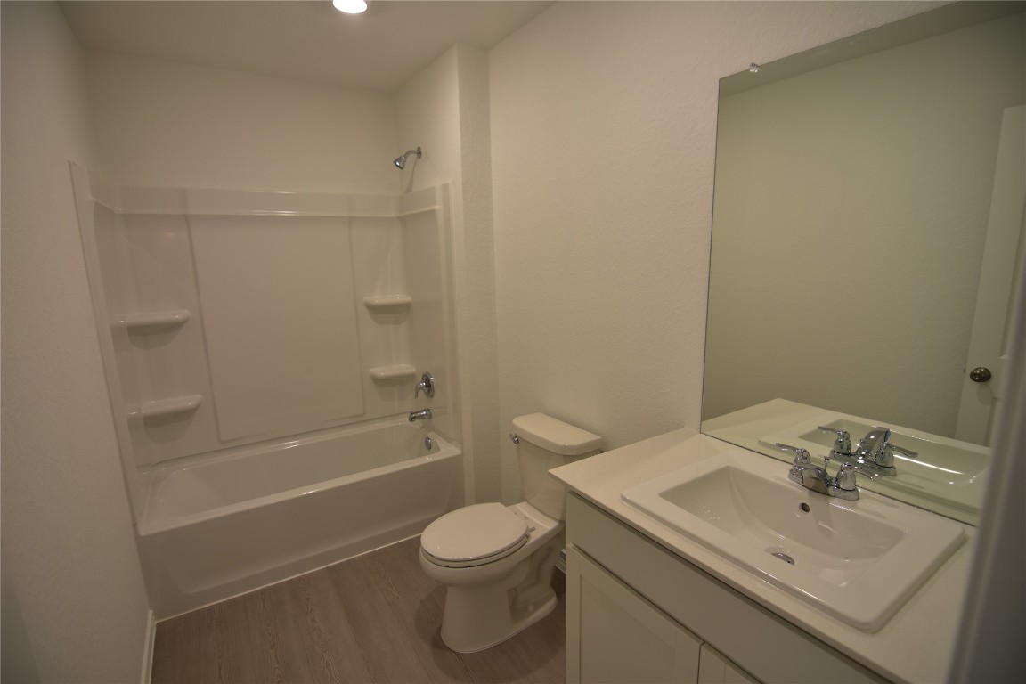 343 Keefer Kyle, TX 78640 - Photo 20 of 38 Full bathroom featuring shower / bath combination, dark wood finished floors, and vanity