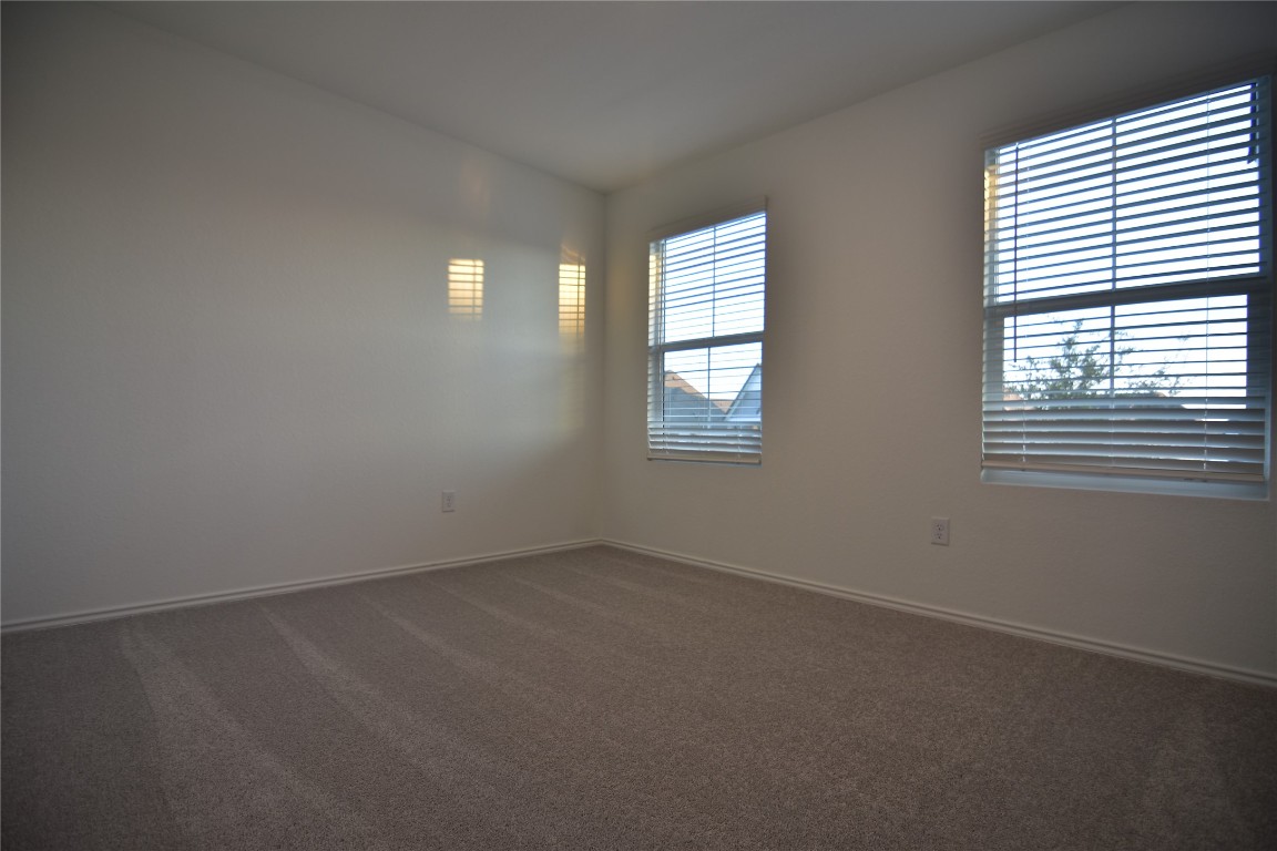 343 Keefer Kyle, TX 78640 - Photo 22 of 38 Unfurnished room with dark carpet and baseboards