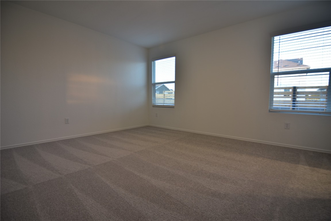 343 Keefer Kyle, TX 78640 - Photo 25 of 38 Empty room featuring dark colored carpet and baseboards