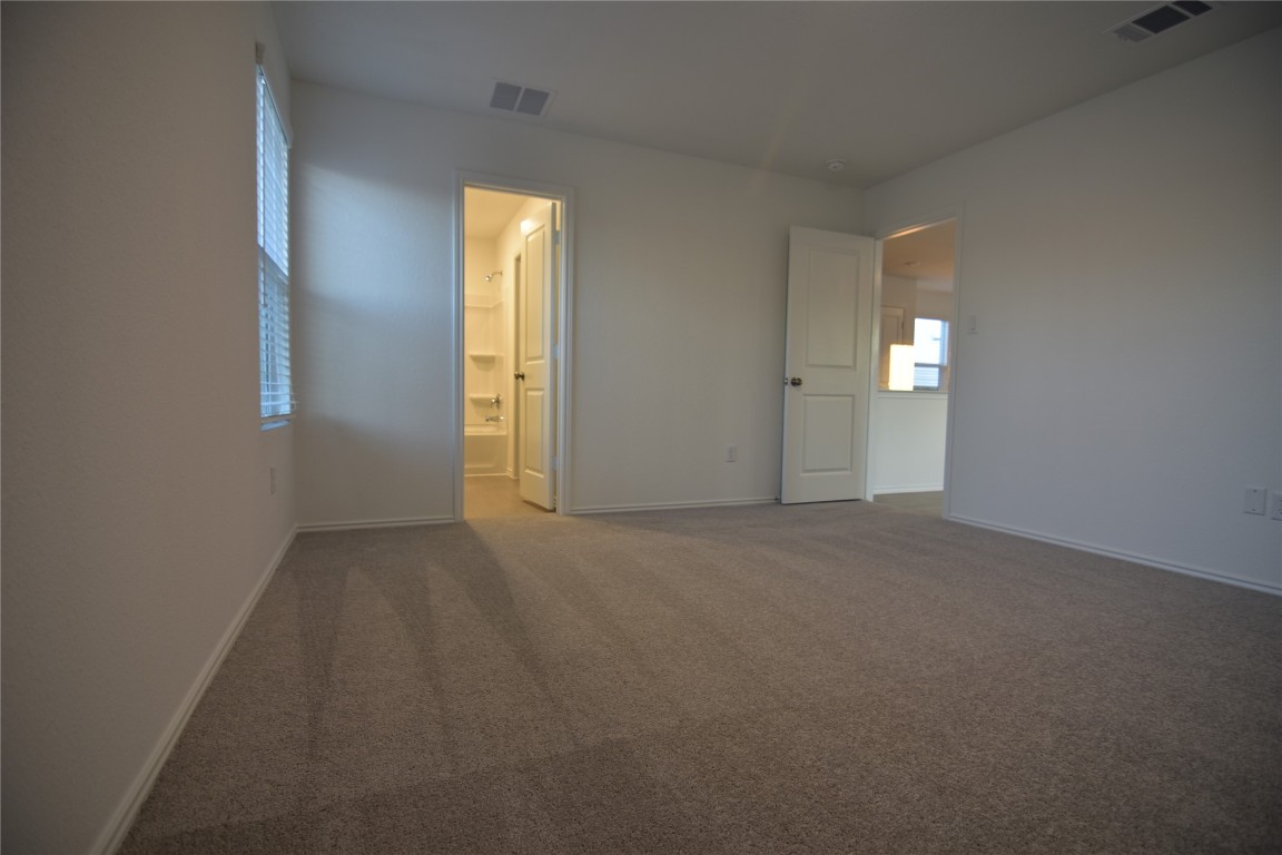 343 Keefer Kyle, TX 78640 - Photo 28 of 38 Unfurnished bedroom with carpet and connected bathroom
