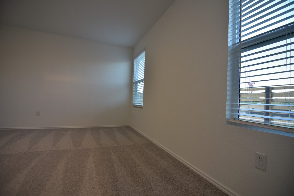 343 Keefer Kyle, TX 78640 - Photo 29 of 38 Carpeted empty room featuring vaulted ceiling and baseboards