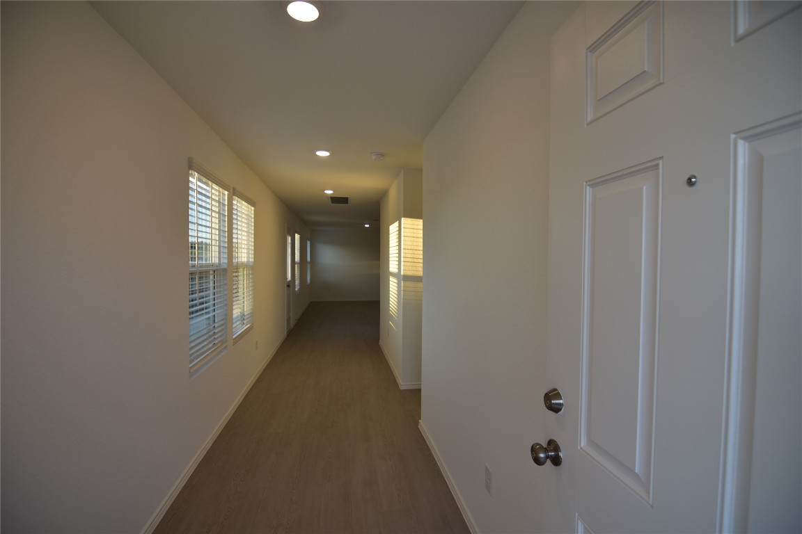 343 Keefer Kyle, TX 78640 - Photo 36 of 38 Corridor with recessed lighting and dark wood-style flooring