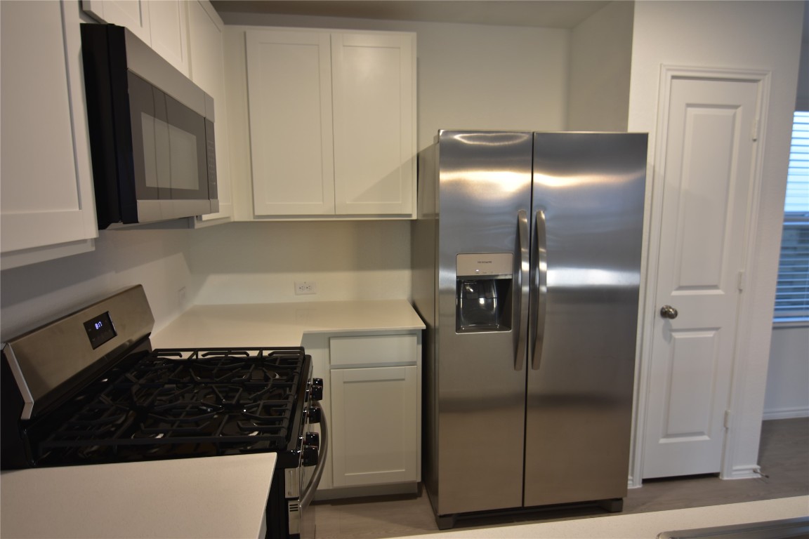 343 Keefer Kyle, TX 78640 - Photo 6 of 38 Kitchen featuring stainless steel appliances and white cabinetry